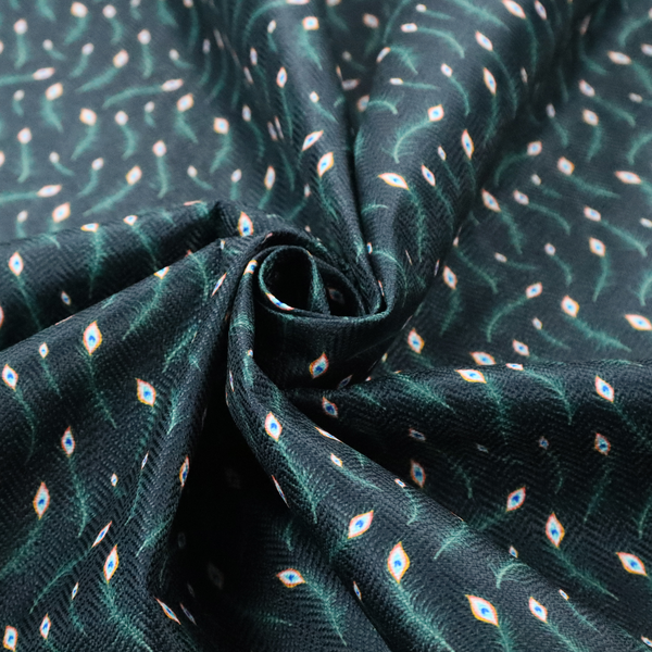 A dense, elegant peacock feather motif. The design showcase a repetitive pattern of small, curved green peacock feathers with bright orange, blue, and white "eyes" floating diagonally. The pattern is set against a dark charcoal grey background that has a subtle, woven herringbone texture.