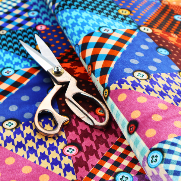 A vibrant, multi-coloured faux patchwork fabric pattern composed of alternating right-angled triangles to form a geometric grid. Each triangular patch features a distinct retro design, including hound's-tooth, gingham checks, diagonal plaids, and polka dots in various scales.