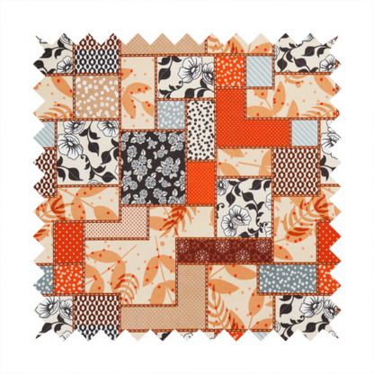 A patchwork fabric pattern featuring a mix of rectangular blocks with floral prints, polka dots, autumn leaves, and geometric shapes in orange, beige, brown, and black-and-white.