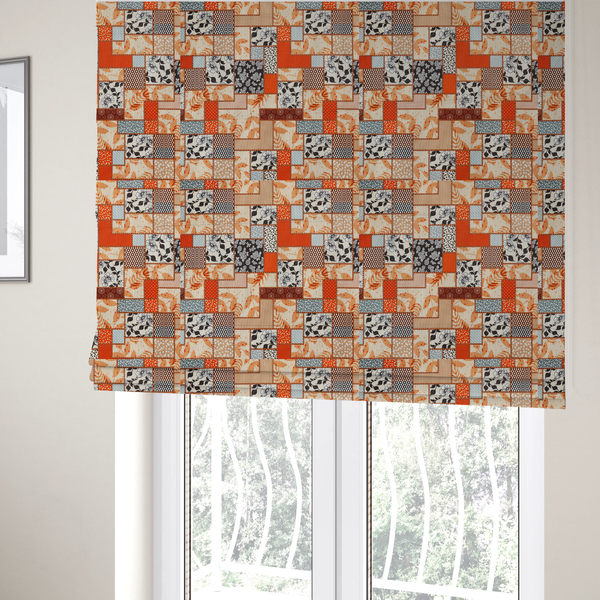 The fabric used to create these Roman blinds is a patchwork fabric pattern featuring a mix of rectangular blocks with floral prints, polka dots, autumn leaves, and geometric shapes in orange, beige, brown, and black-and-white.