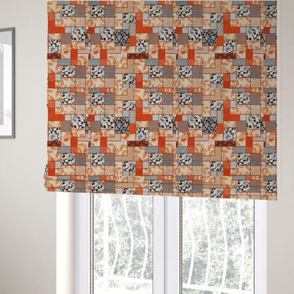 The fabric used to create these Roman blinds is a patchwork fabric pattern featuring a mix of rectangular blocks with floral prints, polka dots, autumn leaves, and geometric shapes in orange, beige, brown, and black-and-white.