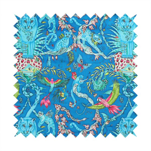 A vibrant turquoise blue fabric featuring an intricate, symmetrical maximalist print of a mythical tropical rainforest. Large, ethereal blue tigers with pink accents are flanked by dense fronds. The repeating pattern is filled with exotic jungle wildlife, including leopards, sloths hanging from vines, winged monkeys, bats, and colourful macaws in shades of bright pink and lime green.
