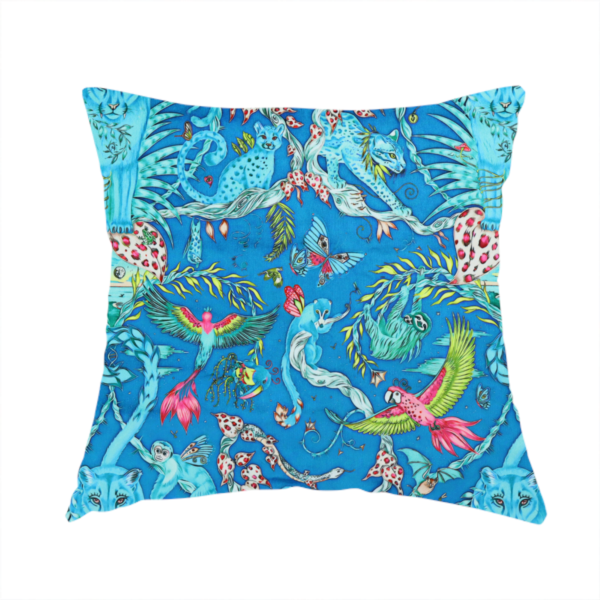 The fabric used to create this handmade cushion is a vibrant turquoise blue fabric featuring an intricate, symmetrical maximalist print of a mythical tropical rainforest. Large, ethereal blue tigers with pink accents are flanked by dense fronds. The repeating pattern is filled with exotic jungle wildlife, including leopards, sloths hanging from vines, winged monkeys, bats, and colourful macaws in shades of bright pink and lime green.
