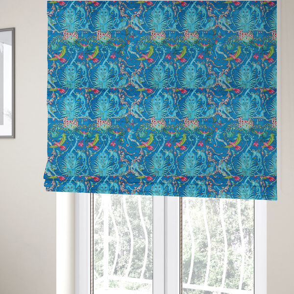 The fabric used to create these Roman blinds is a vibrant turquoise blue fabric featuring an intricate, symmetrical maximalist print of a mythical tropical rainforest. Large, ethereal blue tigers with pink accents are flanked by dense fronds. The repeating pattern is filled with exotic jungle wildlife, including leopards, sloths hanging from vines, winged monkeys, bats, and colourful macaws in shades of bright pink and lime green.