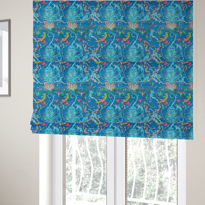 The fabric used to create these Roman blinds is a vibrant turquoise blue fabric featuring an intricate, symmetrical maximalist print of a mythical tropical rainforest. Large, ethereal blue tigers with pink accents are flanked by dense fronds. The repeating pattern is filled with exotic jungle wildlife, including leopards, sloths hanging from vines, winged monkeys, bats, and colourful macaws in shades of bright pink and lime green.