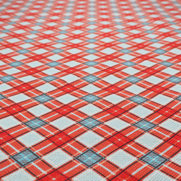 A vibrant diagonal plaid fabric pattern featuring crossing red, light blue, and white stripes on a textured background.