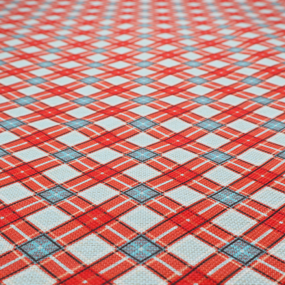 A vibrant diagonal plaid fabric pattern featuring crossing red, light blue, and white stripes on a textured background.