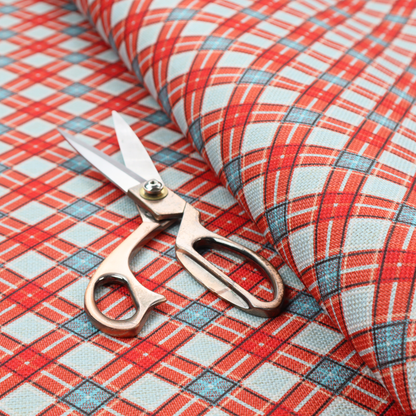 A vibrant diagonal plaid fabric pattern featuring crossing red, light blue, and white stripes on a textured background.
