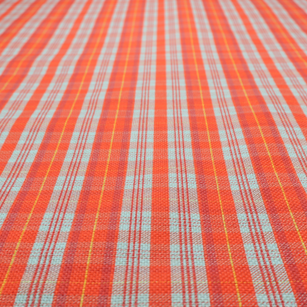 A bright plaid fabric pattern featuring thin, intersecting stripes of orange, light teal, and yellow on a textured background.