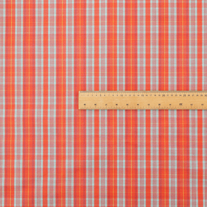 A bright plaid fabric pattern featuring thin, intersecting stripes of orange, light teal, and yellow on a textured background.