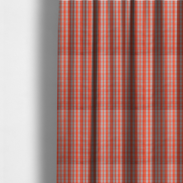 The fabric used to create these made-to-measure curtains is a bright plaid fabric pattern featuring thin, intersecting stripes of orange, light teal, and yellow on a textured background.