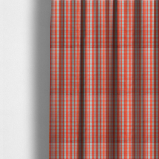 The fabric used to create these made-to-measure curtains is a bright plaid fabric pattern featuring thin, intersecting stripes of orange, light teal, and yellow on a textured background.