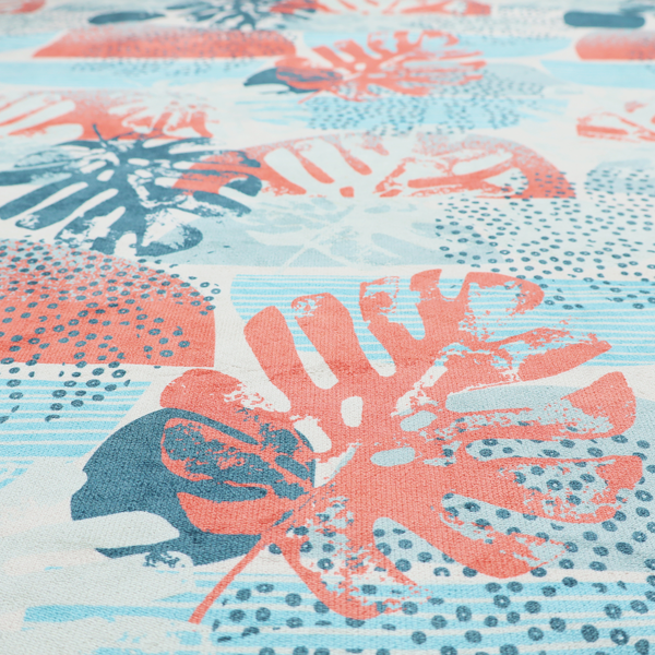 Abstract tropical fabric pattern featuring monstera leaf silhouettes and mid-century geometric shapes in coral, teal, aqua, and cream.