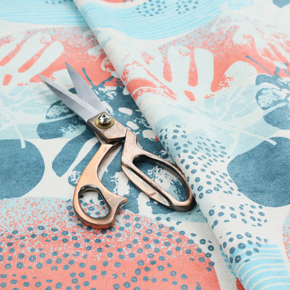 Abstract tropical fabric pattern featuring monstera leaf silhouettes and mid-century geometric shapes in coral, teal, aqua, and cream.