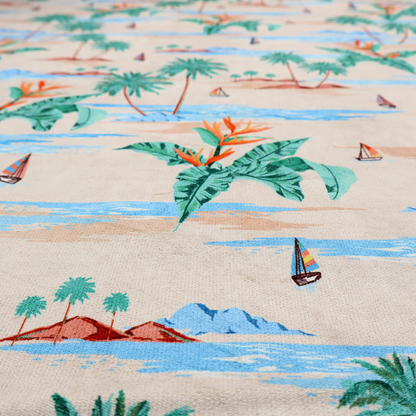 Vintage-style Hawaiian scenic fabric featuring palm trees, small sailboats, and orange Bird of Paradise flowers on a sandy beige background.