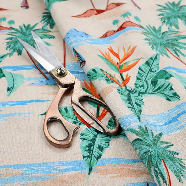 Vintage-style Hawaiian scenic fabric featuring palm trees, small sailboats, and orange Bird of Paradise flowers on a sandy beige background.