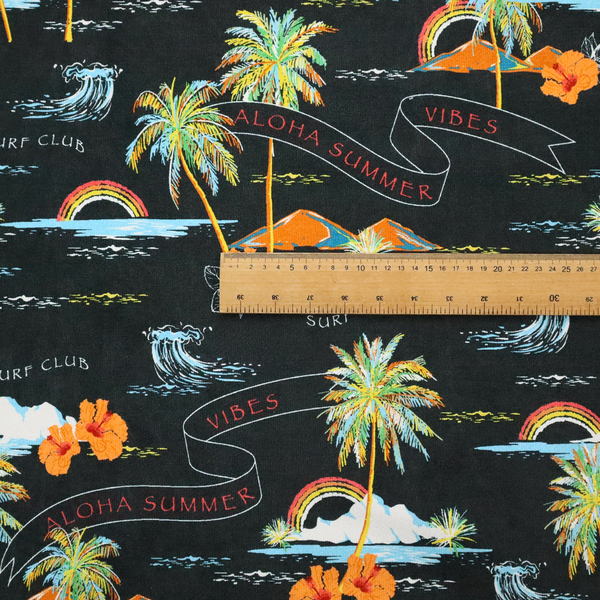 Retro black tropical fabric featuring neon palm trees, rainbows, orange hibiscus flowers, and vintage ribbons reading "Aloha Summer" and "Vibes".