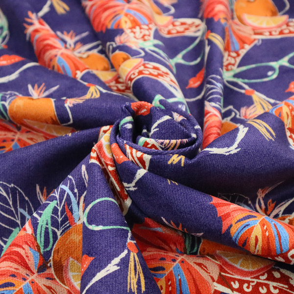 A repeating pattern on dark purple fabric featuring stylized line-art faces of women wearing light green cat-eye sunglasses, bright red lipstick, and elaborate tropical headwraps adorned with orange slices and palm leaves.
