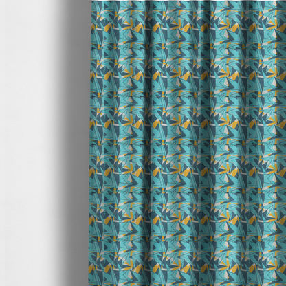 The fabric used to create these made-to-measure curtains is a bold, retro geometric pattern with abstract, sharp arrow and shard shapes in turquoise, slate blue, mustard yellow, and white with a distressed texture.