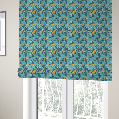 The fabric used to create these Roman blinds is a bold, retro geometric pattern with abstract, sharp arrow and shard shapes in turquoise, slate blue, mustard yellow, and white with a distressed texture.