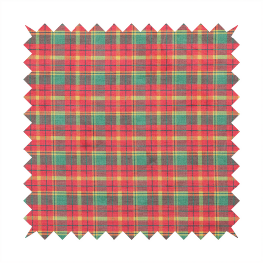 A warm red and green plaid fabric pattern featuring a dense grid of intersecting yellow, dark green, and thin blue stripes.