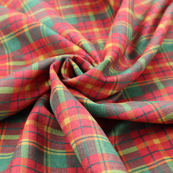 A warm red and green plaid fabric pattern featuring a dense grid of intersecting yellow, dark green, and thin blue stripes.