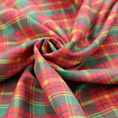A warm red and green plaid fabric pattern featuring a dense grid of intersecting yellow, dark green, and thin blue stripes.