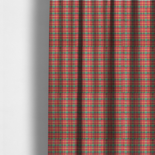 The fabric used to create these made-to-measure curtains is a warm red and green plaid fabric pattern featuring a dense grid of intersecting yellow, dark green, and thin blue stripes.