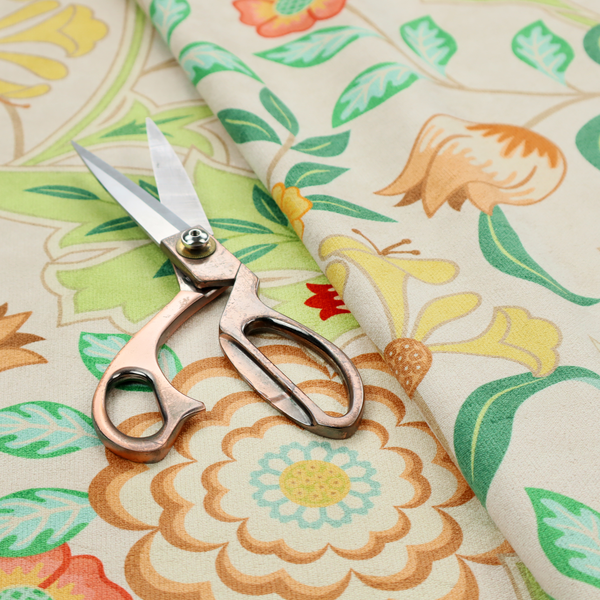 An Arts and Crafts style botanical fabric pattern set against a cream-colored background. The heritage design features winding beige vines interwoven with large, stylized acanthus leaves in soft sage and lime greens.