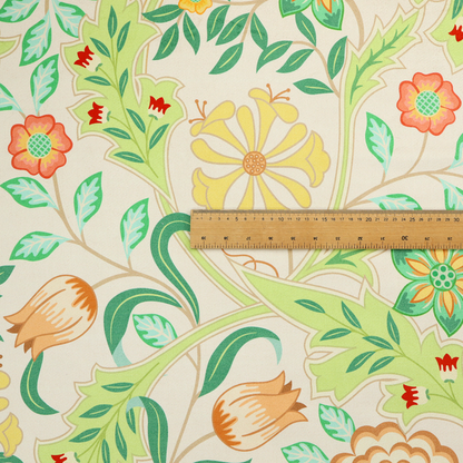 An Arts and Crafts style botanical fabric pattern set against a cream-colored background. The heritage design features winding beige vines interwoven with large, stylized acanthus leaves in soft sage and lime greens.