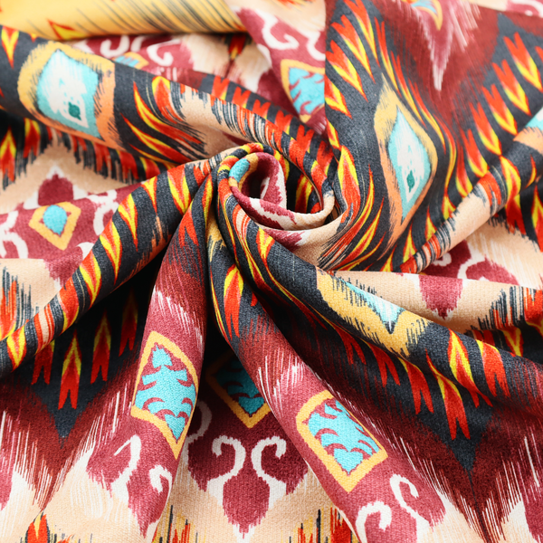 A vibrant, ornate ikat fabric pattern featuring rows of decorative diamond emblems, flame-like borders, and intricate scrollwork motifs in red, black, beige, and turquoise.