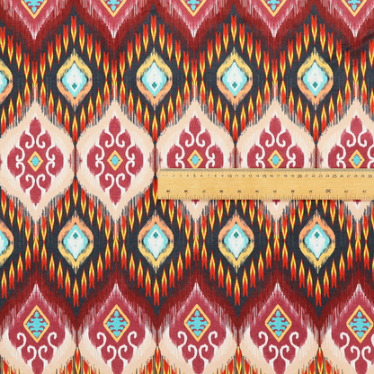 A vibrant, ornate ikat fabric pattern featuring rows of decorative diamond emblems, flame-like borders, and intricate scrollwork motifs in red, black, beige, and turquoise.