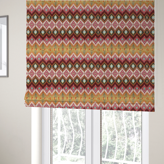 The fabric used to create these Roman blinds is a vibrant, ornate ikat fabric pattern featuring rows of decorative diamond emblems, flame-like borders, and intricate scrollwork motifs in red, black, beige, and turquoise.