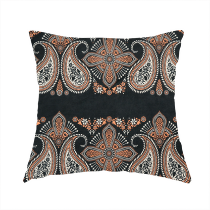 The fabric used to create this handmade cushion is a black fabric pattern featuring elegant horizontal bands of intricate paisley motifs and ornate cross-shaped designs in cream and terracotta orange.