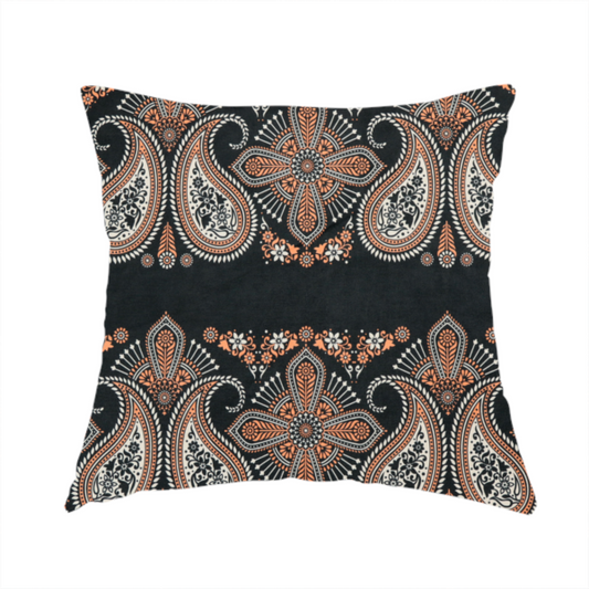 The fabric used to create this handmade cushion is a black fabric pattern featuring elegant horizontal bands of intricate paisley motifs and ornate cross-shaped designs in cream and terracotta orange.