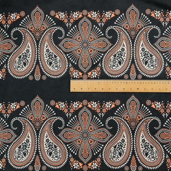 A black fabric pattern featuring elegant horizontal bands of intricate paisley motifs and ornate cross-shaped designs in cream and terracotta orange.