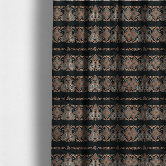 The fabric used to create these made-to-measure curtains is a black fabric pattern featuring elegant horizontal bands of intricate paisley motifs and ornate cross-shaped designs in cream and terracotta orange.