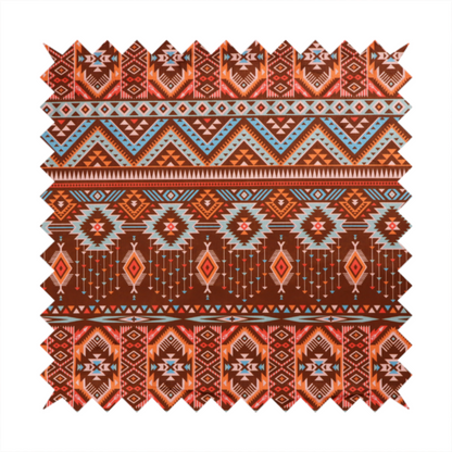 A brown fabric pattern featuring southwest-inspired geometric bands with zigzags, diamonds, and native-style motifs in terracotta, light blue, and cream.
