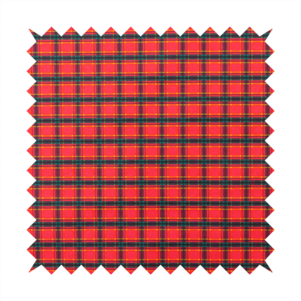 A vibrant red plaid fabric pattern featuring a dense grid of intersecting dark green and thin yellow stripes.