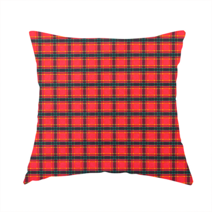 The fabric used to create this handmade cushion is a vibrant red plaid fabric pattern featuring a dense grid of intersecting dark green and thin yellow stripes.