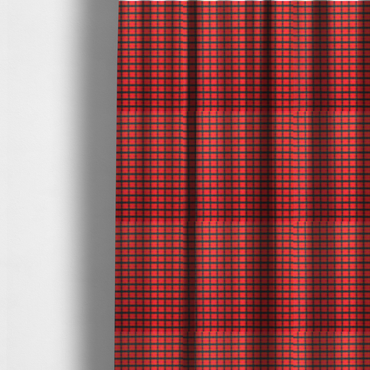 The fabric used to create these made-to-measure curtains is a vibrant red plaid fabric pattern featuring a dense grid of intersecting dark green and thin yellow stripes.