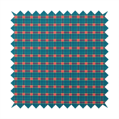 A rich teal plaid fabric pattern featuring a dense grid of intersecting dark blue and thin yellow stripes with bright red square accents.