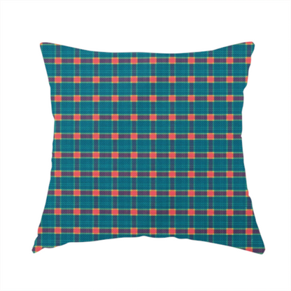 The fabric used to create this handmade cushion is a rich teal plaid fabric pattern featuring a dense grid of intersecting dark blue and thin yellow stripes with bright red square accents.