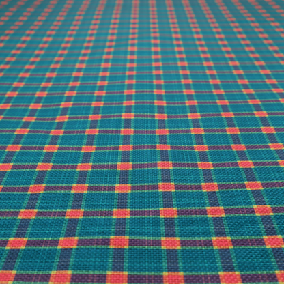 A rich teal plaid fabric pattern featuring a dense grid of intersecting dark blue and thin yellow stripes with bright red square accents.