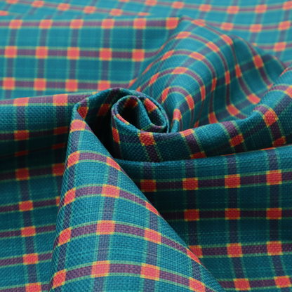 A rich teal plaid fabric pattern featuring a dense grid of intersecting dark blue and thin yellow stripes with bright red square accents.