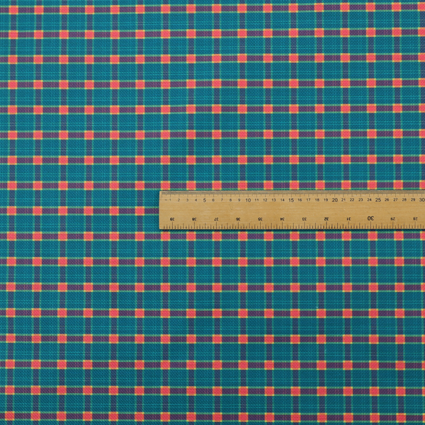 A rich teal plaid fabric pattern featuring a dense grid of intersecting dark blue and thin yellow stripes with bright red square accents.