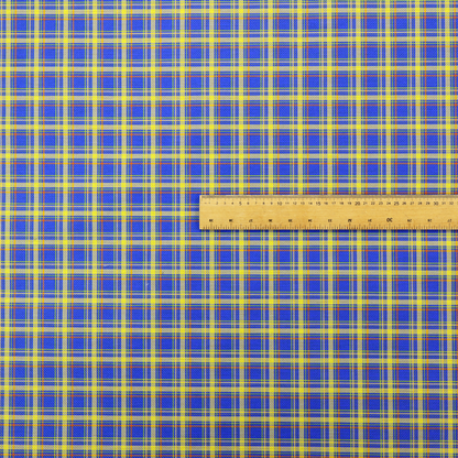 A bright blue plaid fabric pattern featuring a tight, repeating grid of intersecting yellow stripes and thin orange accent lines.