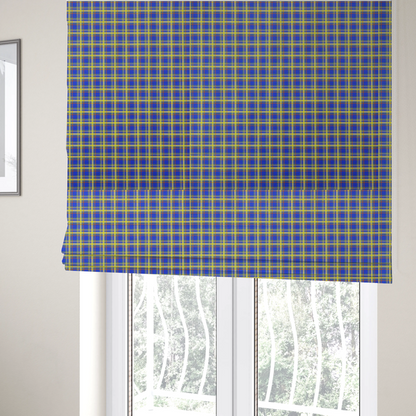 The fabric used to create these Roman blinds is a bright blue plaid fabric pattern featuring a tight, repeating grid of intersecting yellow stripes and thin orange accent lines.