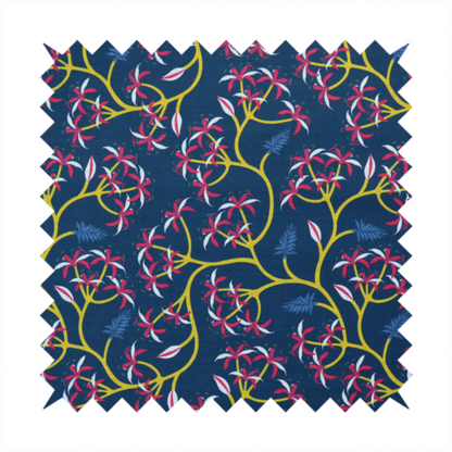 A deep blue fabric pattern featuring a winding trail of bright yellow vines accented with clusters of pink and white flowers and blue fern leaves.