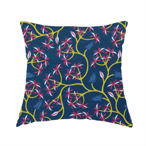 The fabric used to create this handmade cushion is a deep blue fabric pattern featuring a winding trail of bright yellow vines accented with clusters of pink and white flowers and blue fern leaves.